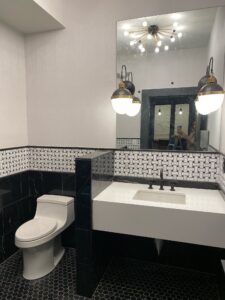Modern Bathroom with Black & White Tile, Vanity & Chic Pendants